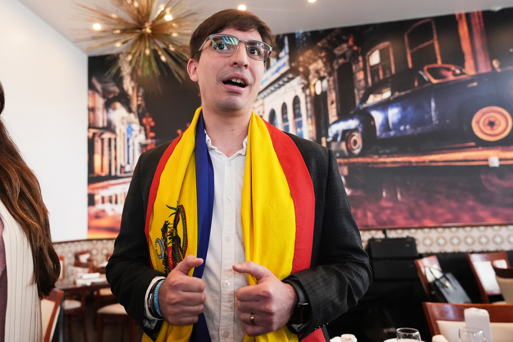 Jorge Galicia, a Venezuelan political activist who requested asylum seven years ago, wears a Venezuelan flag around his neck, as he talks about his support of the capture of Venezuelan President Nicolas Maduro by the U.S., Monday, Jan. 5, 2026, in Doral, Fla. (AP Photo/Lynne Sladky)