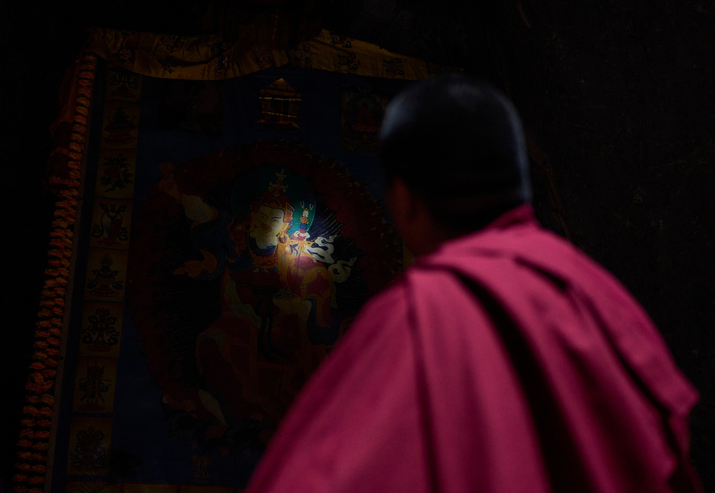Jalue Dorje looks at a painting inside Maratika Caves, 135 miles east from Kathmandu, Nepal, Monday, April 13, 2026. (AP Photo/Niranjan Shrestha)