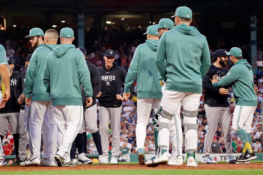 Boston Red Sox and New York Yankees players and coaches clear the benches during the fifth inning of a baseball game, Friday, June 26, 2026, in Boston. (AP Photo/Mary Schwalm)