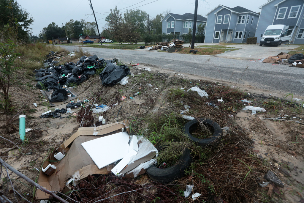 Piles of trash fill the ditch across a construction site in the Trinity Gardens neighborhood in northwest Houston, Thursday, Dec. 4, 2025. (AP Photo/Lekan Oyekanmi )
