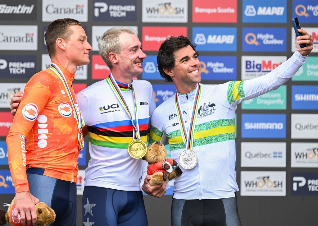Brandon McNulty, of the United States, centre, Michael Matthews, of Australia, right, and Mathieu van der Poel, of the Netherlands, pose for a selfie following the men's elite road race at the UCI Road World Championships cycling event in Montreal on Sunday, Sept. 27, 2026. (Graham Hughes/The Canadian Press via AP)