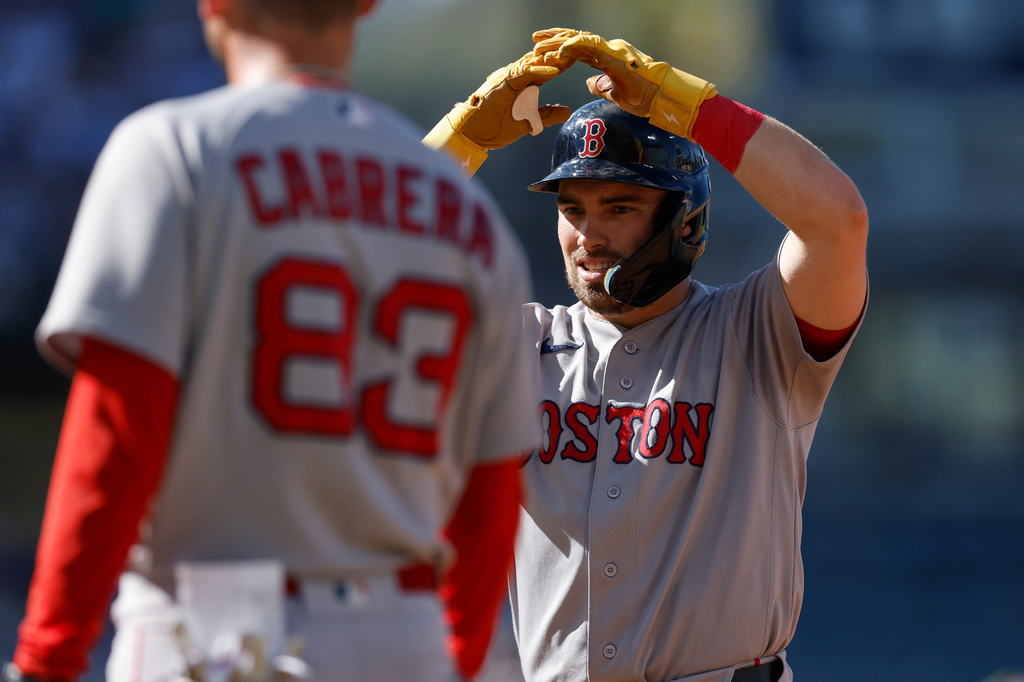 Boston Red Sox's Caleb Durbin, right, reacts after hitting an RBI single during the first inning of a baseball game against the Los Angeles Dodgers, Sunday, Aug. 2, 2026, in Los Angeles. (AP Photo/Caroline Brehman)