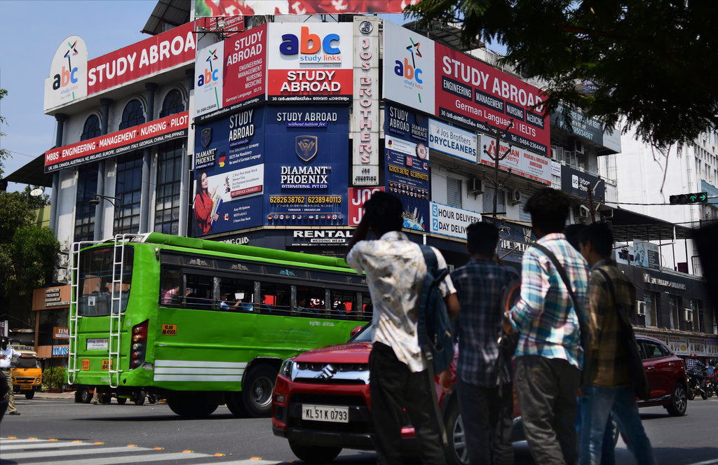 FILE - Sign boards of various educational consultants that attract youth to study abroad cover the façade of a building in Kochi, Kerala state, India, March 7, 2023. (AP Photo/ R S Iyer, File)