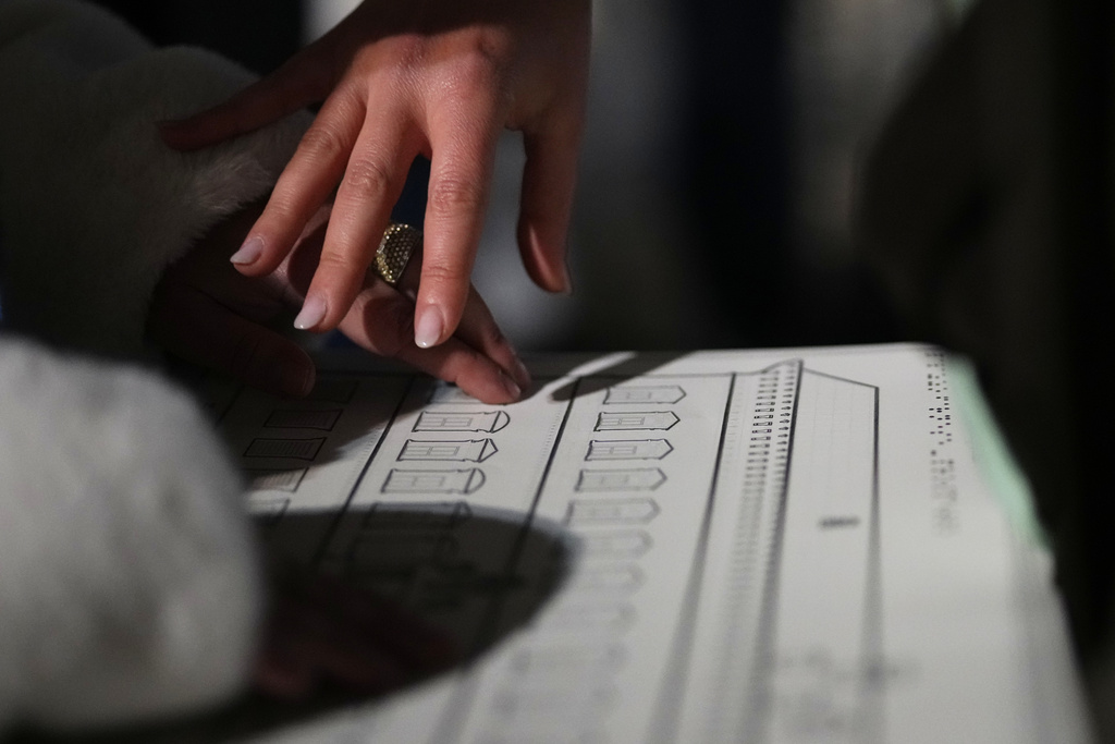 Francesca Inglese, who is blind, uses a tactile panel to experience the architecture of Palazzo Farnese during an inclusive art tour in downtown Rome, Nov. 29, 2025. (AP Photo/Alessandra Tarantino)