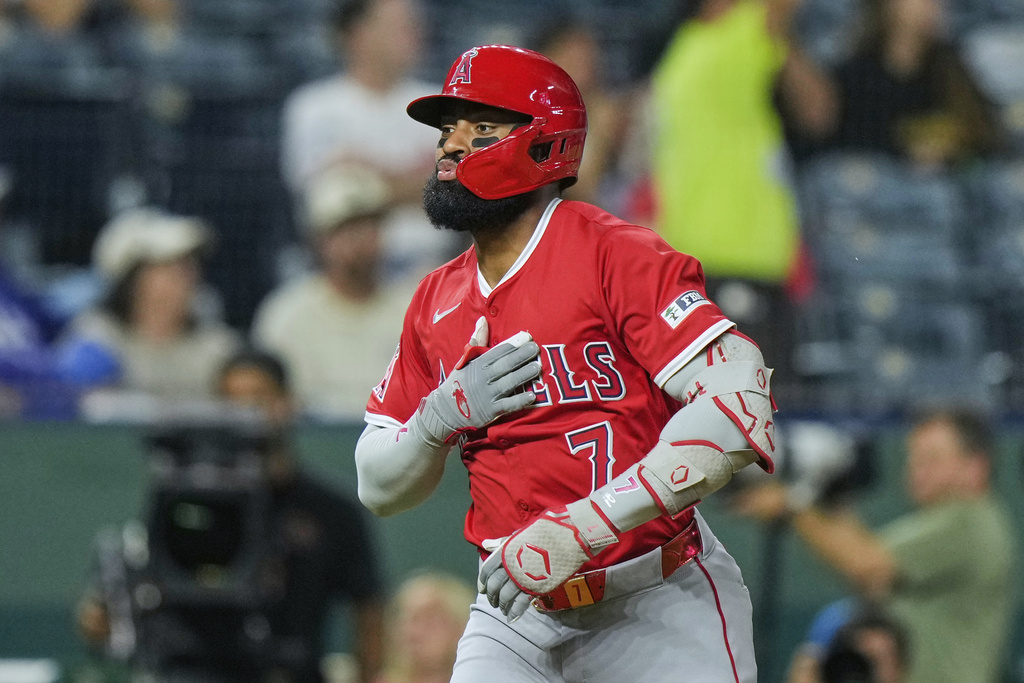 Los Angeles Angels' Jo Adell celebrates as he crosses the plate after hitting a three-run home run during the sixth inning of a baseball game against the Kansas City Royals, Wednesday, Sept. 3, 2025, in Kansas City, Mo. (AP Photo/Charlie Riedel)