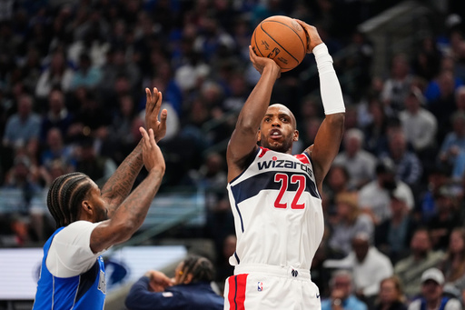 Washington Wizards forward Khris Middleton (22) shoots as Dallas Mavericks' Naji Marshall, left, defends in the first half of an NBA basketball game, Friday, Oct. 24, 2025, in Dallas. (AP Photo/Tony Gutierrez) Washington Wizards forward Khris Middleton (22) shoots as Dallas Mavericks' Naji Marshall, left, defends in the first half of an NBA basketball game, Friday, Oct. 24, 2025, in Dallas. (AP Photo/Tony Gutierrez)