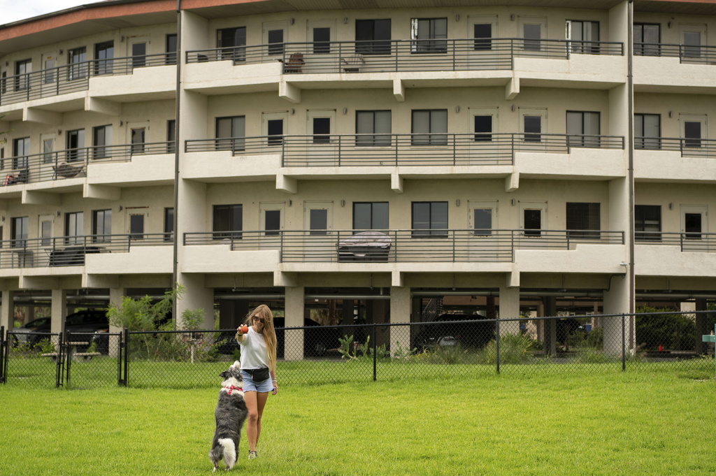 Sophie Nocera, 21, a senior at Eckerd College, plays with her dog Zuco on Wednesday, Aug. 20, 2025 in St. Petersburg, Fla. (AP Photo/Tina Russell)