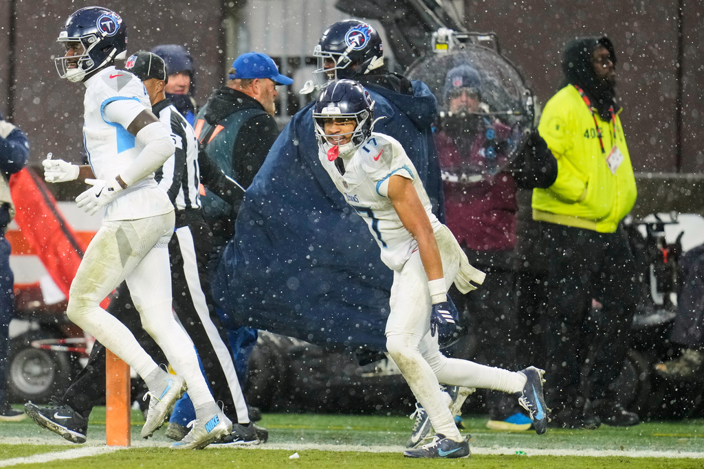 Tennessee Titans wide receiver Chimere Dike (17) celebrates with teammates after catching a touchdown pass in the second half of an NFL football game against the Cleveland Browns in Cleveland, Sunday, Dec. 7, 2025. (AP Photo/Sue Ogrocki)