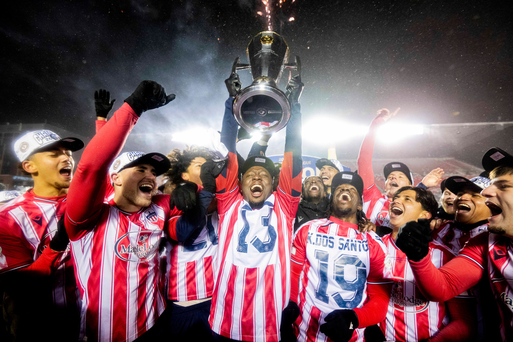 Atletico Ottawa's Ballou Tabla (13) raises the North Star Cup following Atletico Ottawa's victory over Cavalry FC in extra time during the Canadian Premier League finals soccer action in Ottawa, on Sunday, Nov. 9, 2025. (Spencer Colby/The Canadian Press via AP)