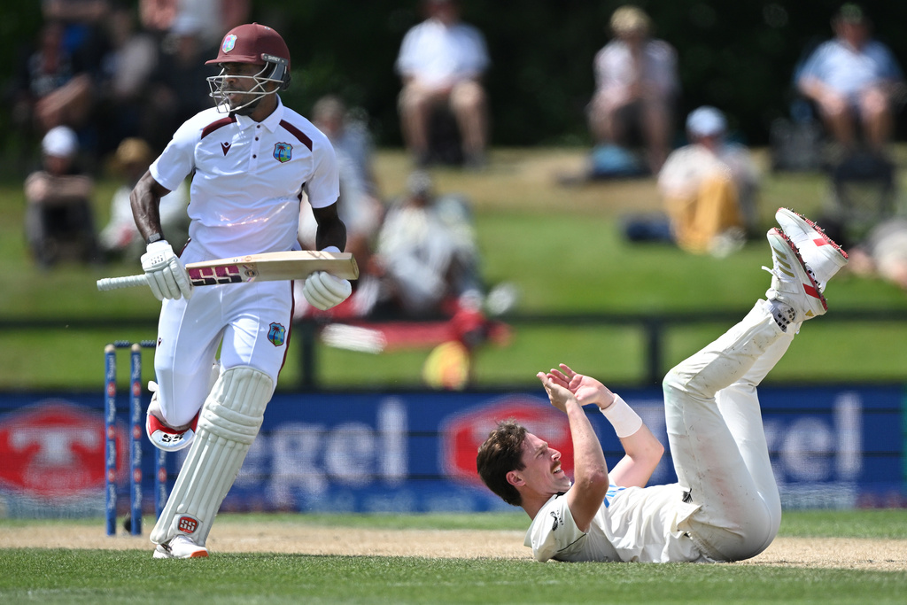 West Indies's Justin Greaves, left, takes a run as New Zealand's bowler Matt Henry falls to the ground on Day 4 of their cricket test match in Christchurch, New Zealand, Friday, Dec. 5, 2025. (Andrew Cornaga/Photosport via AP)