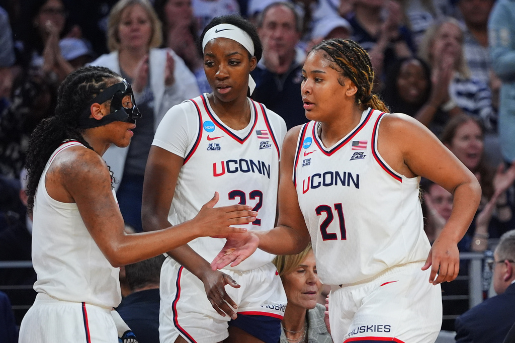 UConn's KK Arnold, left, Serah Williams (22) and Sarah Strong (21) celebrate late in the second half in the Sweet 16 of the NCAA college basketball tournament against North Carolina, Friday, March 27, 2026, in Fort Worth, Texas. (AP Photo/LM Otero)