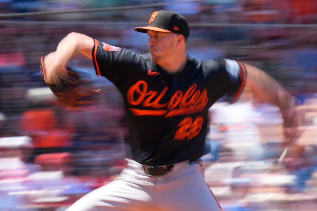 In this image taken with a slow shutter speed, Baltimore Orioles starting pitcher Trevor Rogers delivers during the third inning of a baseball game against the Boston Red Sox, Thursday, June 4, 2026, in Boston. (AP Photo/Charles Krupa)