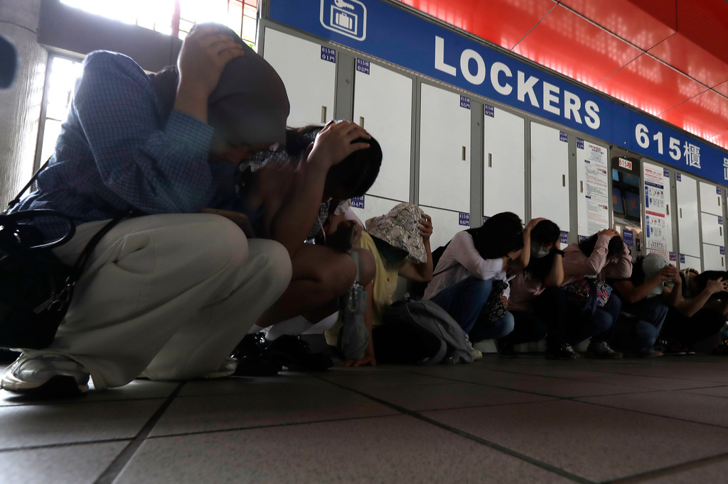 People take cover inside at a MRT station during the Urban Resilience (Air-Defense) Exercise, part of the annual Han Kuang military exercises in Taipei, Taiwan, Thursday, Aug. 13, 2026. (AP Photo/Chiang Ying-ying)