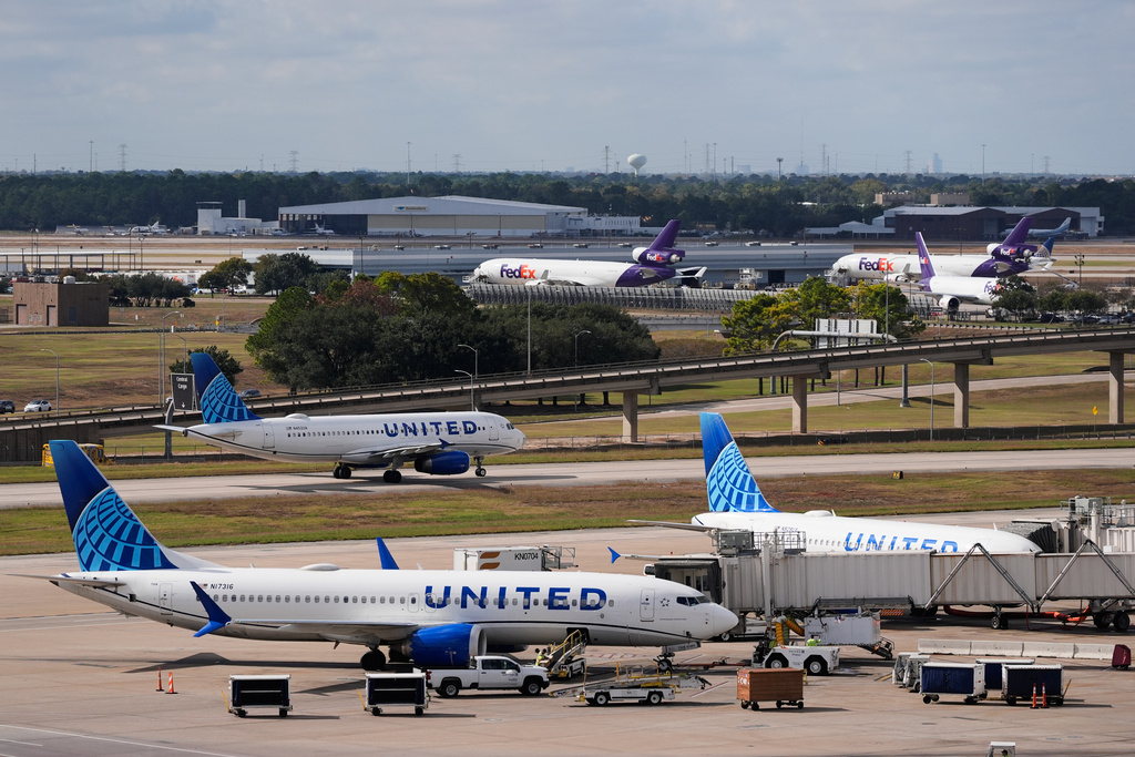 United Airlines and FedEx prepare for departure at George Bush Intercontinental Airport on Friday, Nov. 7, 2025, in Houston. (AP Photo/Ashley Landis)