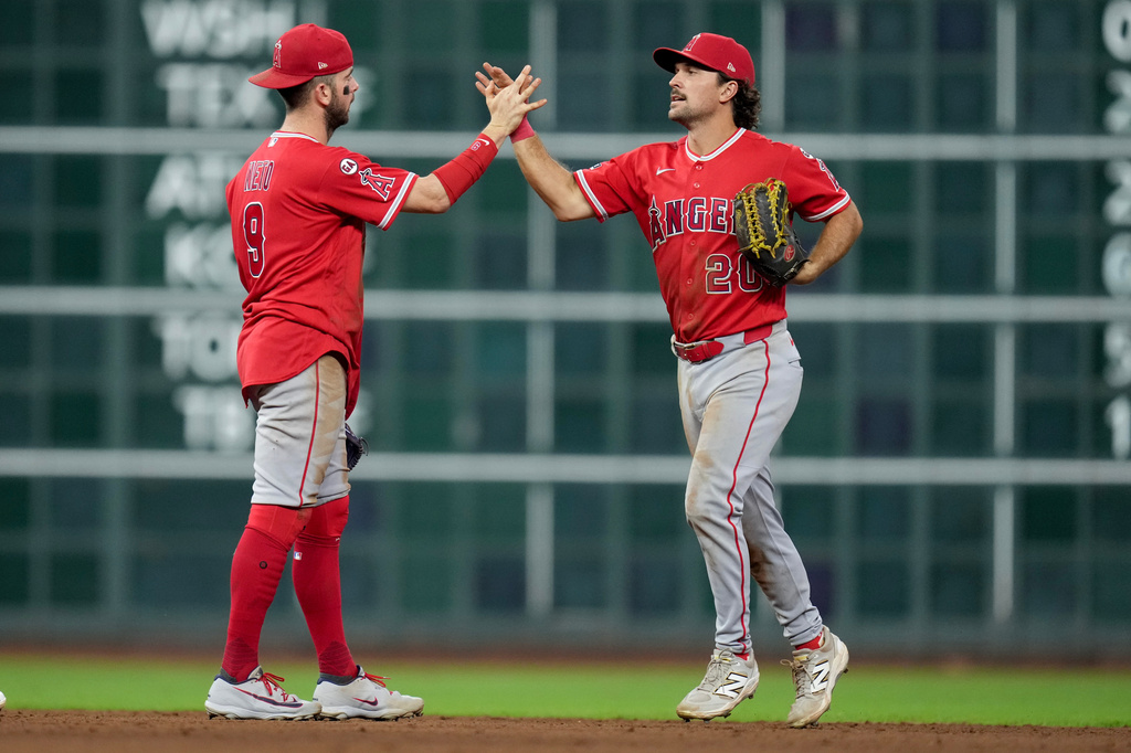 Los Angeles Angels' Zach Neto, left, and Adam Frazier celebrate the team's win over the Houston Astros in a baseball game Thursday, Aug. 20, 2026, in Houston. (AP Photo/Eric Christian Smith)
