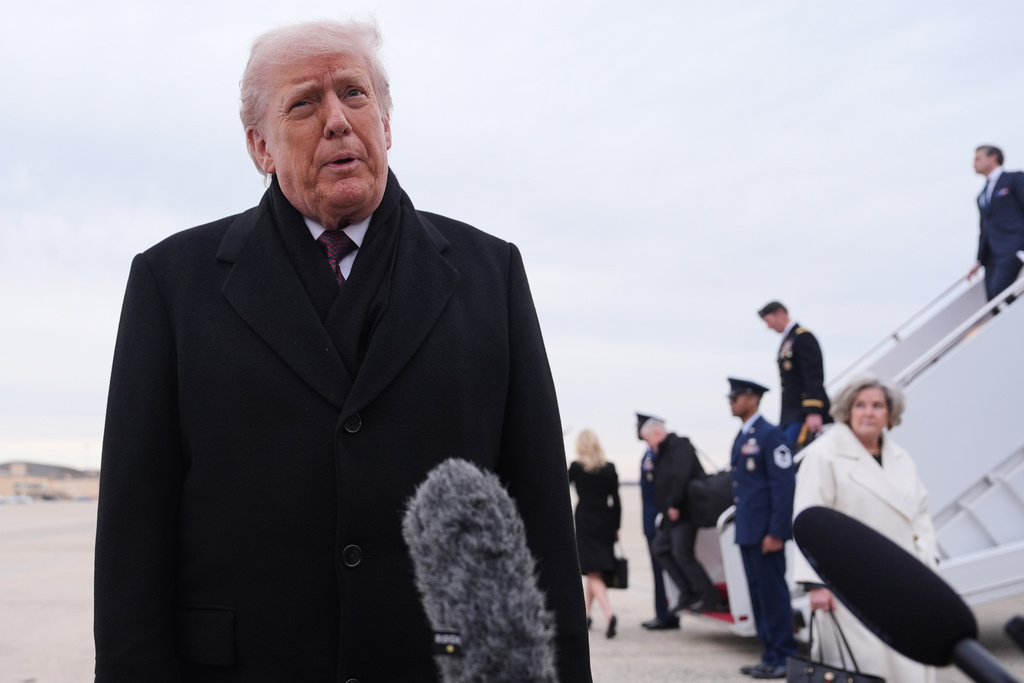 President Donald Trump talks to reporters after arriving on Air Force One, Wednesday, Dec. 17, 2025, at Joint Base Andrews, Md., after attending a casualty return at Dover Air Foce Base. (AP Photo/Evan Vucci)
