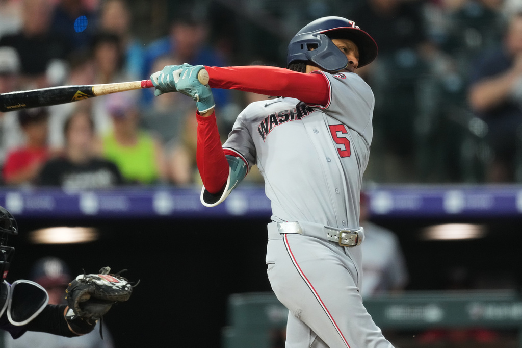 Washington Nationals' CJ Abrams follows through with his swing after connecting for a two-run home run off Colorado Rockies relief pitcher Antonio Senzatela in the seventh inning of a baseball game Monday, July 20, 2026, in Denver. (AP Photo/David Zalubowski)