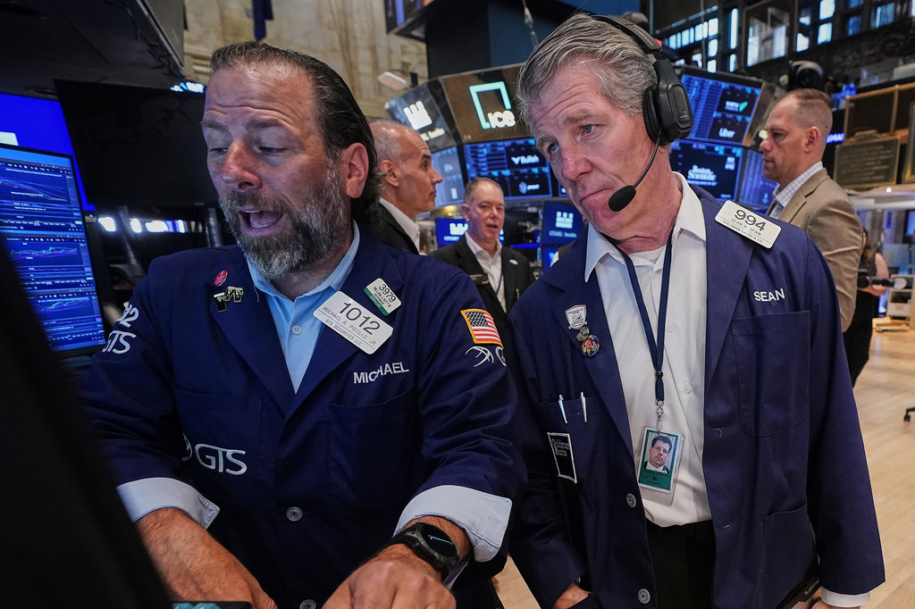 Specialist Michael Pistillo, left, and trader Sean Spain work on the floor of the New York Stock Exchange, Tuesday, June 16, 2026. (AP Photo/Richard Drew)