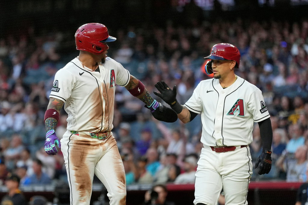 Arizona Diamondbacks' Ketel Marte, left, celebrates his run scored against the Pittsburgh Pirates with Diamondbacks' Ildemaro Vargas during the first inning of a baseball game, Tuesday, May 5, 2026, in Phoenix. (AP Photo/Ross D. Franklin)