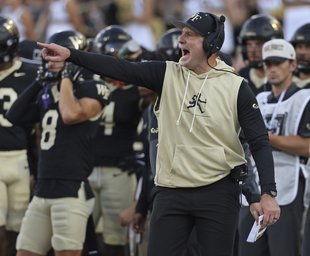 Wake Forest head coach Jake Dickert, front right, directs his players in the first half of an NCAA college football game against Kennesaw State, Friday, Aug. 29, 2025, in Winston-Salem, N.C. (Walt Unks/The Winston-Salem Journal via AP)
