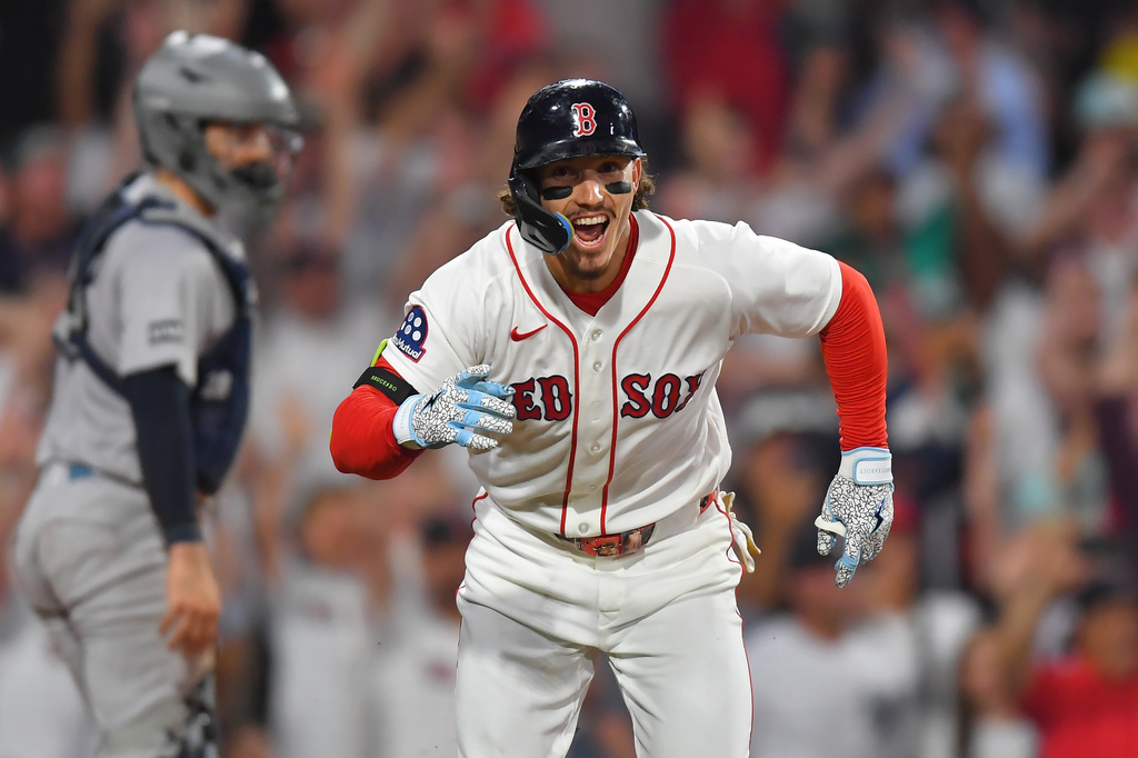 Boston Red Sox's Jarren Duran, right, celebrates in front of New York Yankees catcher Austin Wells, left, after hitting a walk-off one-run single in the tenth inning of a baseball game, Sunday, June 28, 2026, in Boston. (AP Photo/Steven Senne)