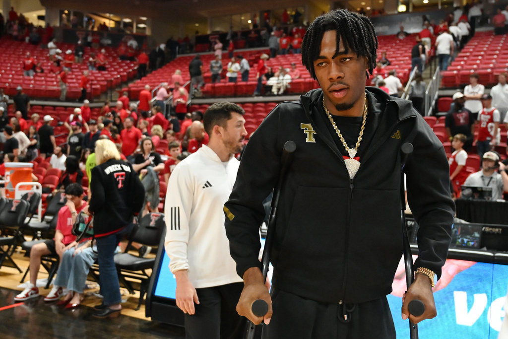 Texas Tech forward JT Toppin uses crutches to walk after the end of an NCAA college basketball game against TCU, Tuesday, March 3, 2026, in Lubbock, Texas. (AP Photo/Annie Rice)