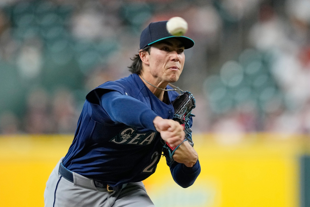 Seattle Mariners starting pitcher Bryan Woo throws against the Houston Astros during the first inning of a baseball game Tuesday, May 12, 2026, in Houston. (AP Photo/David J. Phillip)