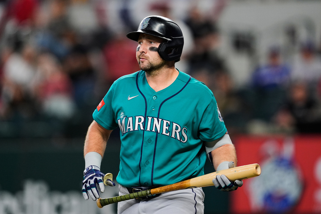 Seattle Mariners' Cal Raleigh walks to the dugout after striking out in the first inning of a baseball game against the Texas Rangers Wednesday, April 8, 2026, in Arlington, Texas. (AP Photo/Tony Gutierrez)