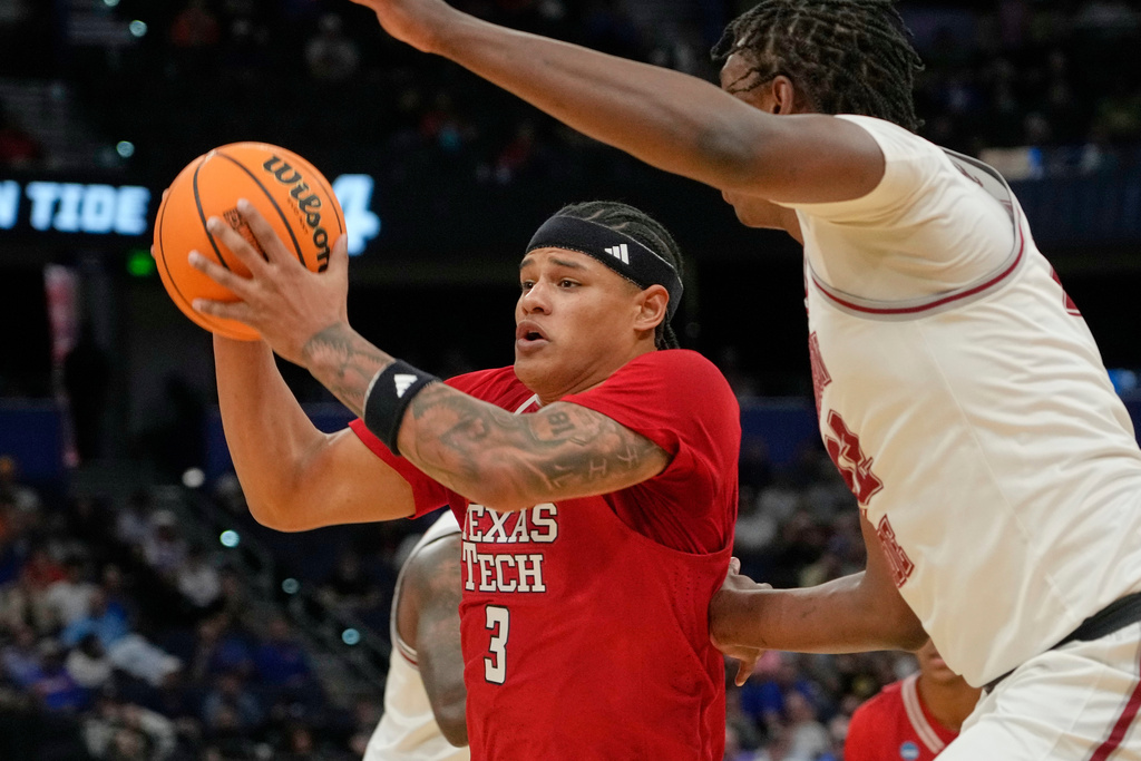 Texas Tech forward LeJuan Watts goes to the basket against Alabama forward Aiden Sherrell during the first half in the second round of the NCAA college basketball tournament, Sunday, March 22, 2026, in Tampa, Fla. (AP Photo/John Raoux)