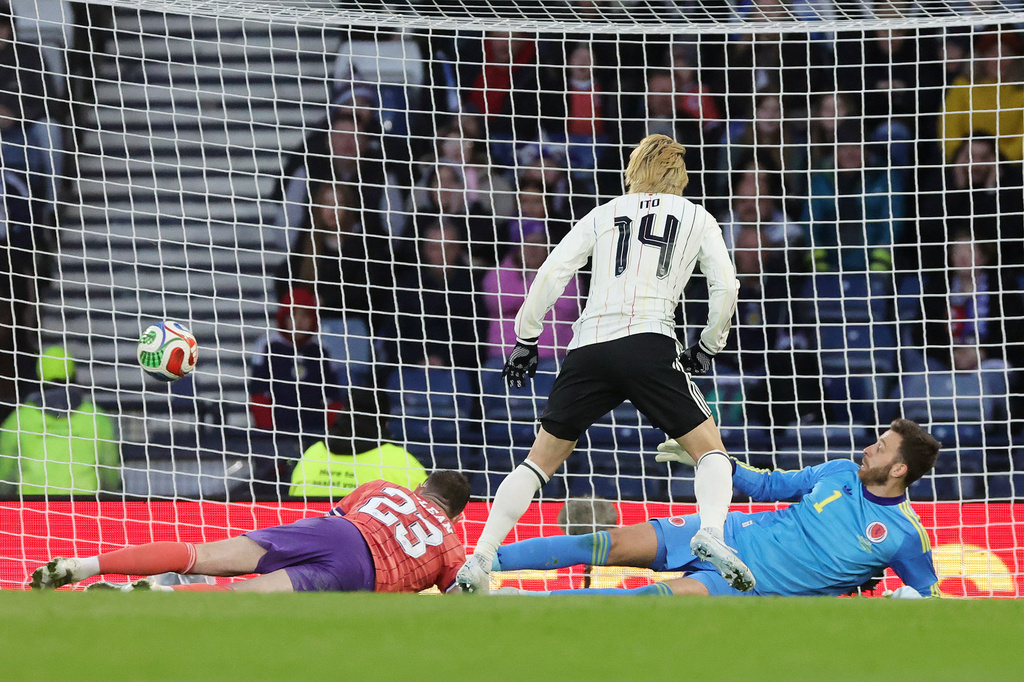 Japan's Junya Ito scores the opening goal during the international friendly soccer match against Scotland, in Glasgow, Scotland, Saturday March 28, 2026. (Steve Welsh/PA via AP)