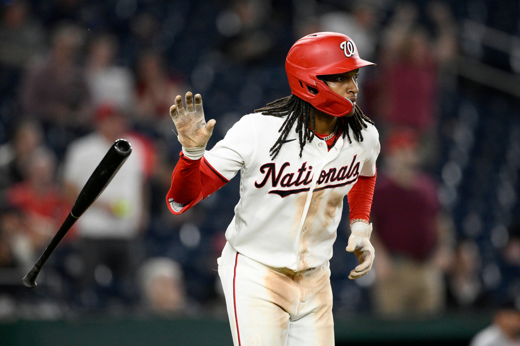 Washington Nationals' CJ Abrams tosses his bat as he watches his grand slam during the eighth inning of a baseball game against the Minnesota Twins, Wednesday, May 6, 2026, in Washington. (AP Photo/Nick Wass)