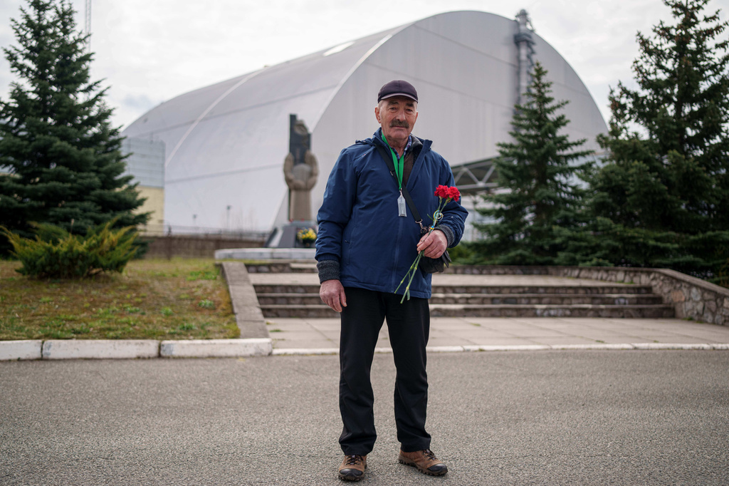 Anatolii Krutik, 63, who helped clean up contamination from the Chernobyl nuclear power plant accident, poses for a portrait Tuesday, April 21, 2026, in front of the plant in Chernobyl, Ukraine. (AP Photo/Evgeniy Maloletka)