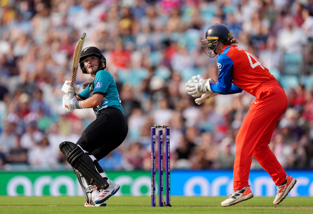 New Zealand's Melie Kerr, left, batting as England wicket keeper Amy Jones looks on during the Women's T20 World Cup cricket match between England and New Zealand at The Kia Oval in London, Saturday June 27, 2026. (Ben Whitley/PA via AP)