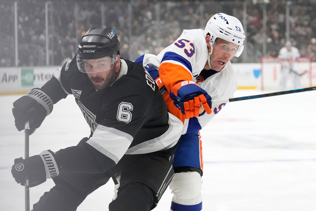 New York Islanders center Casey Cizikas, right, tries to get past Los Angeles Kings defenseman Joel Edmundson during the first period of an NHL hockey game Thursday, March 5, 2026, in Los Angeles. (AP Photo/Mark J. Terrill)