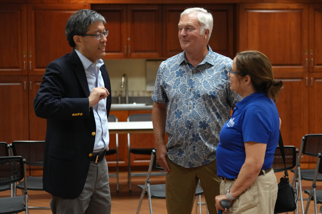 Richard Pan, left, the Democratic candidate for the California 6th District seat in the House of Representatives in the Nov. 3 election talks with Charlie Brown, center and Karen Alvord, vice mayor of Roseville, during a campaign gathering in Roseville, Calif., Thursday, Aug. 6, 2026.(AP Photo/Rich Pedroncelli)