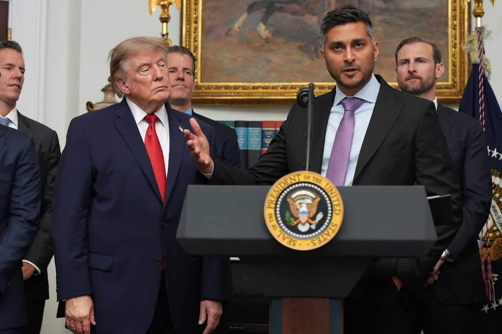 FILE - Kraken co-CEO Arjun Sethi speaks as President Donald Trump listens during a meeting with technology leaders in the Roosevelt Room of the White House, Aug. 19, 2026, in Washington. (AP Photo/Jacquelyn Martin, File)