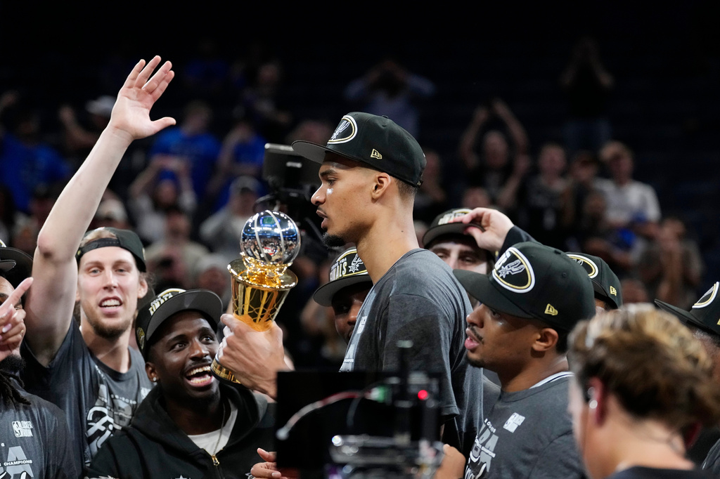 San Antonio Spurs forward Victor Wembanyama holds the MVP trophy as he celebrates with teammates after Game 7 of the Western Conference finals of the NBA basketball playoffs series win against the Oklahoma City Thunder, Saturday, May 30, 2026, in Oklahoma City. (AP Photo/Tony Gutierrez)
