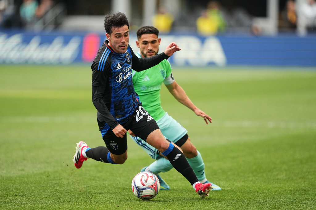 San Jose Earthquakes midfielder Nick Fernandez, front, moves the ball against Seattle Sounders midfielder Cristian Roldan, back, during the first half of an MLS soccer match, Wednesday, May 13, 2026, in Seattle. (AP Photo/Lindsey Wasson)
