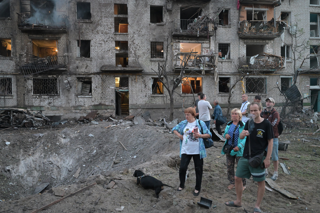 People look at the site of a Russian missile strike that hit a residential building in Kyiv, Ukraine, Thursday, July 2, 2026. (AP Photo/Danylo Antoniuk)