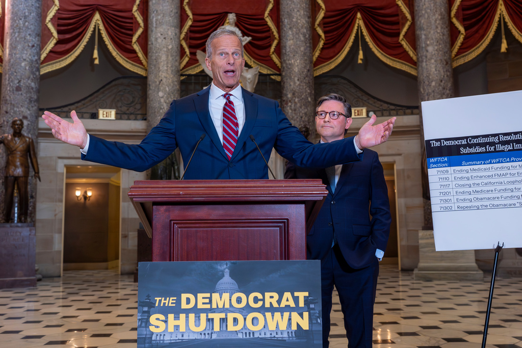 Senate Majority Leader John Thune, R-S.D., center, and Speaker of the House Mike Johnson, R-La., and right, talk with reporters in Statuary Hall on the third day of the government shutdown, at the Capitol in Washington, Friday, Oct. 3, 2025. (AP Photo/J. Scott Applewhite)