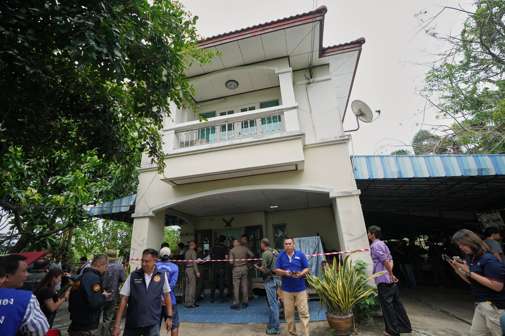Police stand outside the home a student shot several people Friday at the Debsirin Nonthaburi School in Thailand's Nonthaburi province, Friday, Aug. 7, 2026. (AP Photo/Sakchai Lalit)