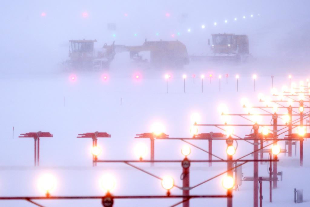 Snowplows clear a runway at Manchester-Boston Regional Airport during a winter storm, Monday, Feb. 23, 2026, in Londonderry, N.H. (AP Photo/Charles Krupa)