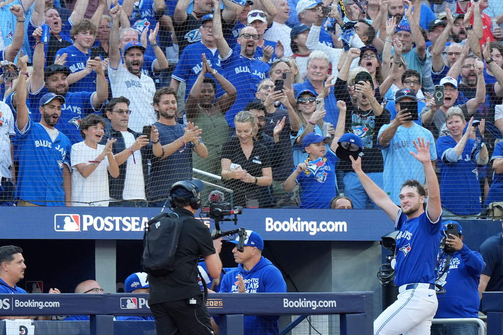 CORRECTS TO SIXTH INNING NOT FIFTH INNING - Toronto Blue Jays pitcher Trey Yesavage, front right, comes out to a standing ovation as he greets fans after he was pulled from the mound during the sixth inning of Game 2 of baseball's American League Division Series in Toronto, Sunday, Oct. 5, 2025. (Frank Gunn/The Canadian Press via AP)