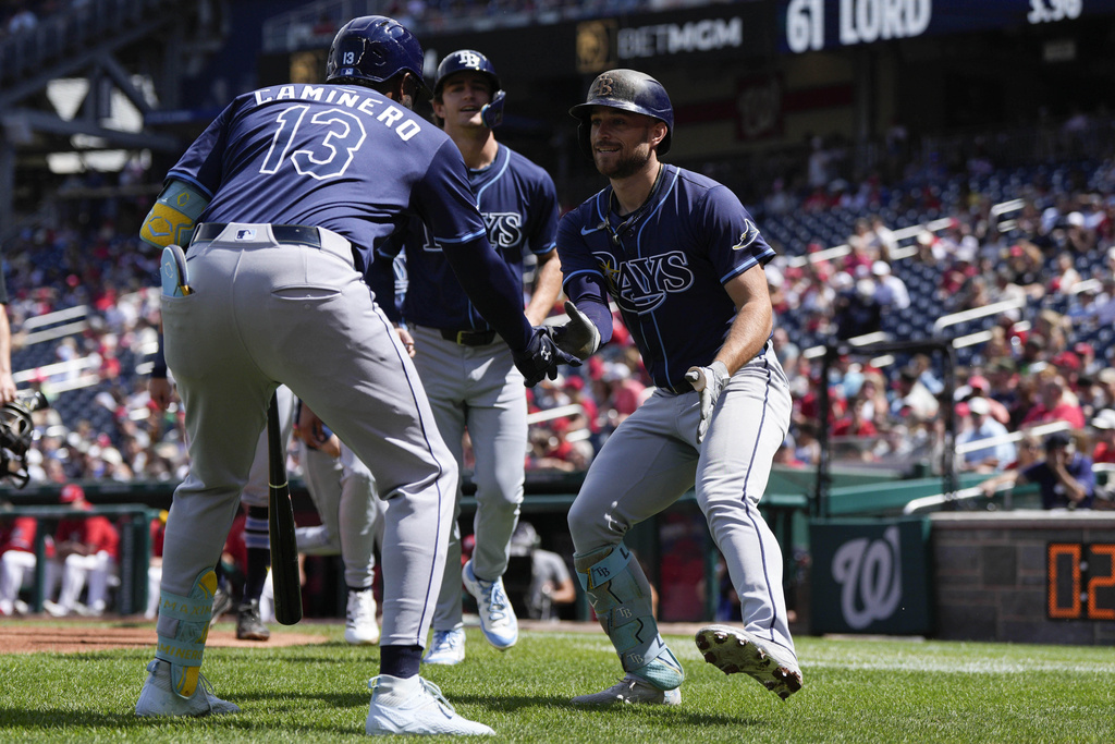 Tampa Bay Rays designated hitter Brandon Lowe, right, celebrates his grand slam against the Washington Nationals with teammate Junior Caminero (13) during the second inning of a baseball game at Nationals Park, Sunday, Aug. 31, 2025, in Washington. (AP Photo/Jess Rapfogel)
