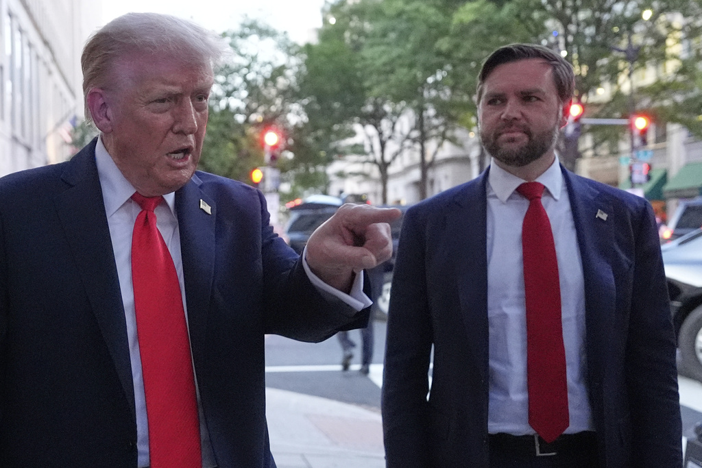 President Donald Trump talks to reporters as he arrives for dinner at a restaurant near the White House, Tuesday, Sept. 9, 2025, in Washington, with Vice President JD Vance. (AP Photo/Alex Brandon)