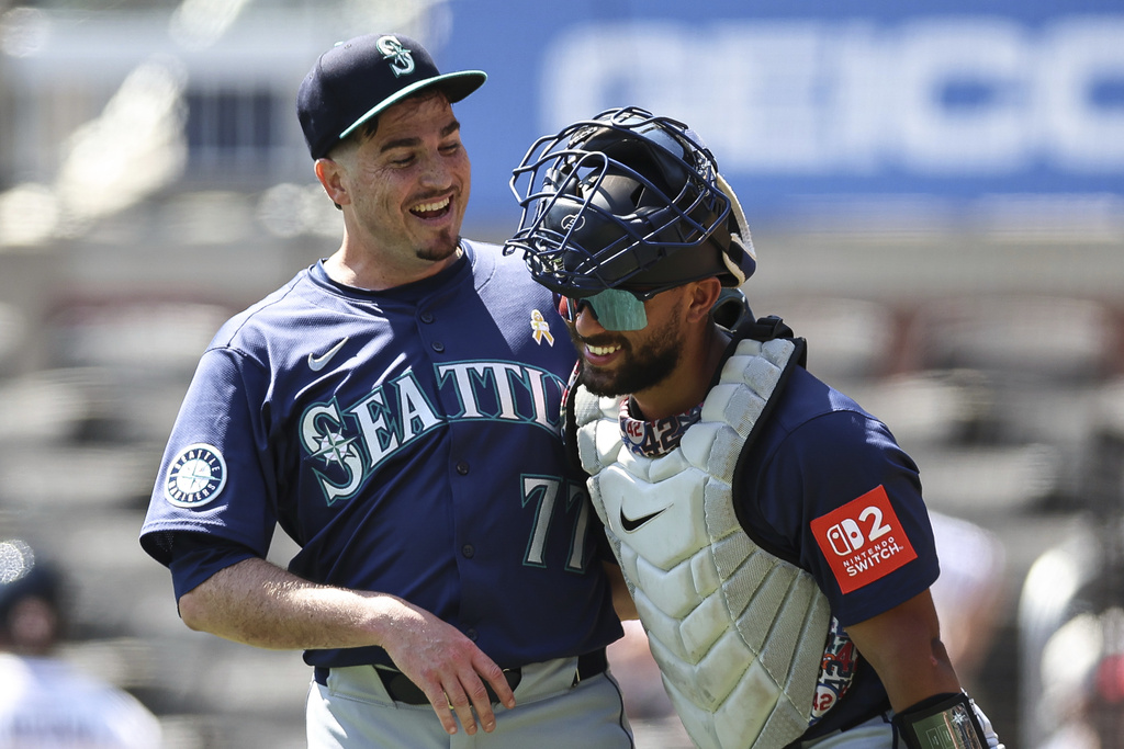 Seattle Mariners pitcher Luke Jackson (77) and catcher Harry Ford, right, react after a baseball game against the Atlanta Braves, Sunday, Sept. 7, 2025, in Atlanta. (AP Photo/Colin Hubbard)