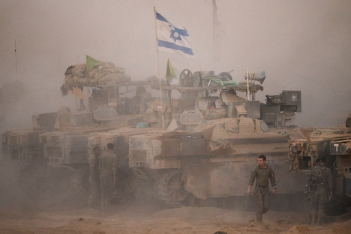 Israeli soldiers stand near their tanks along the Israeli-Gaza border, as seen from southern Israel, Friday, Oct. 10, 2025, after Israel and Hamas have agreed to a pause in their war and the release of the remaining hostages. (AP Photo/Emilio Morenatti) Israeli soldiers stand near their tanks along the Israeli-Gaza border, as seen from southern Israel, Friday, Oct. 10, 2025, after Israel and Hamas have agreed to a pause in their war and the release of the remaining hostages. (AP Photo/Emilio Morenatti)