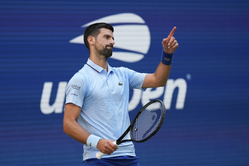 Novak Djokovic, of Serbia, reacts to a shot against Carlos Alcaraz, of Spain, during the men's singles semifinals of the U.S. Open tennis championships, Friday, Sept. 5, 2025, in New York. (AP Photo/Seth Wenig)