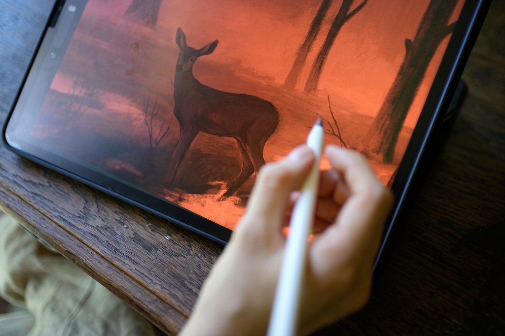 Illustrator Marina Antonova works on a drawing for her series called "Chronicles of a Heating Planet" in Beaumont-les-Valence, southern France, on Sept. 12, 2026. (AP Photo/Laurent Cipriani)