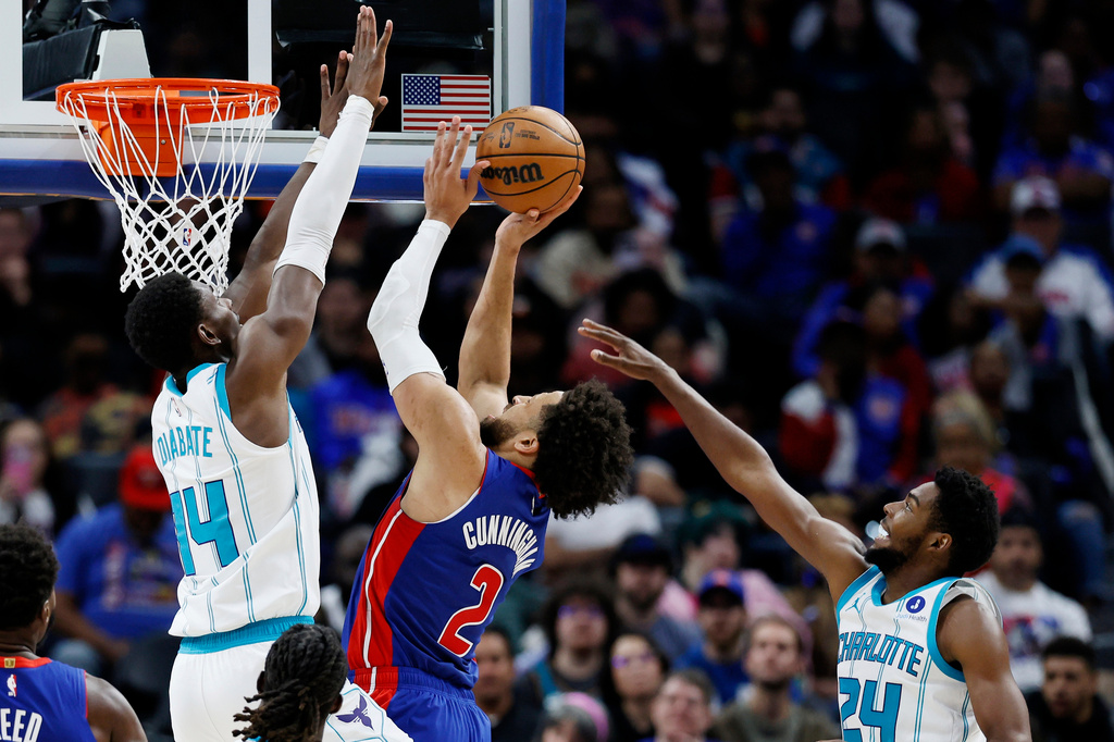 Detroit Pistons guard Cade Cunningham (2) goes to the basket against Charlotte Hornets forward Moussa Diabate (14) and forward Brandon Miller (24) during the first half of an NBA basketball game Wednesday, Oct. 28, 2026, in Detroit. (AP Photo/Duane Burleson)